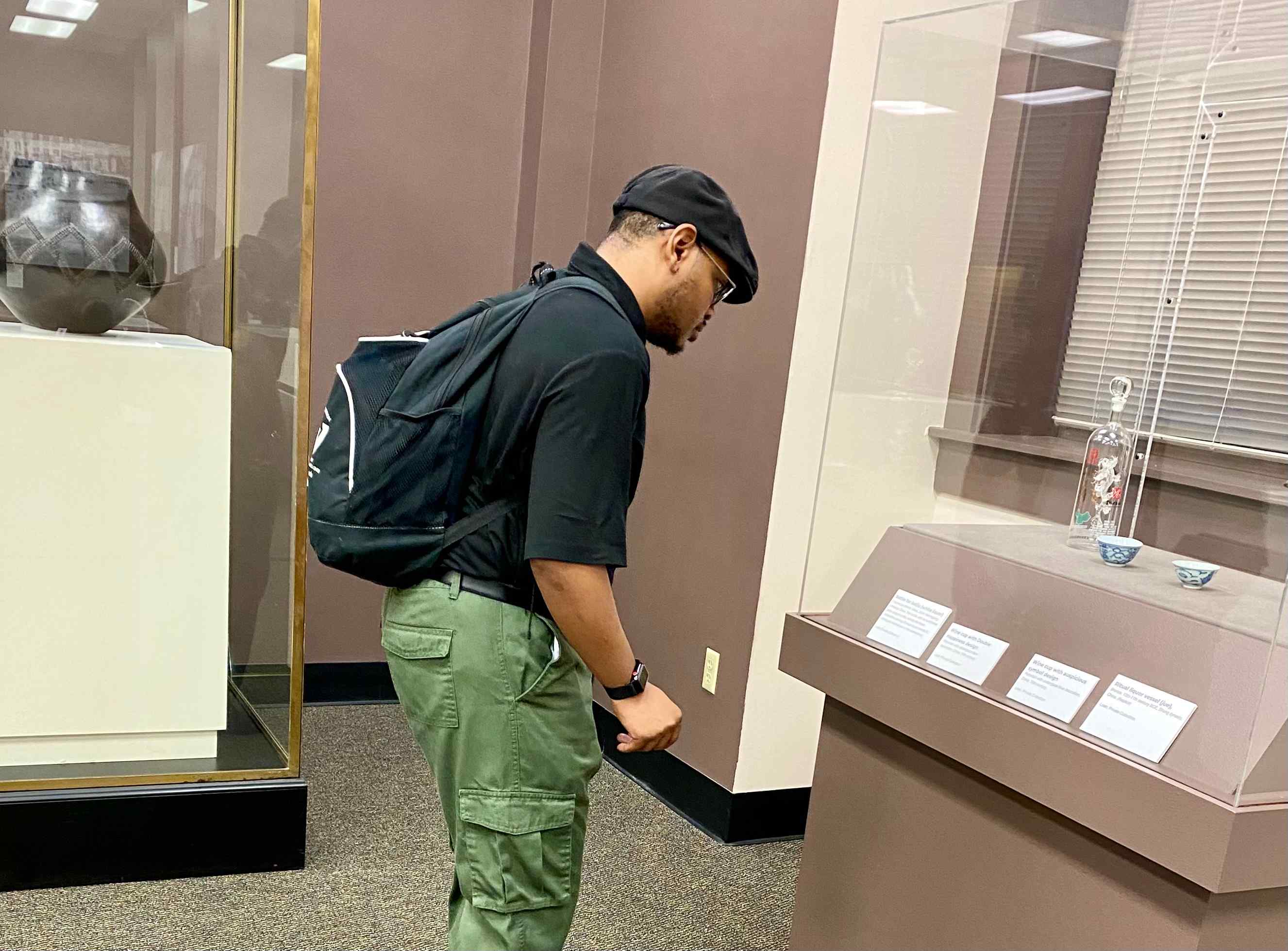 A museum visitor looks at Chinese items