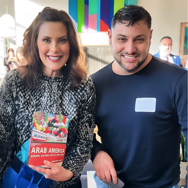 Photo of Dr. Tareq Ramadan with Governor Gretchen Whitmer holding a copy of Arab America: Gender, Cultural Politics, and Activism by Nadine Naber