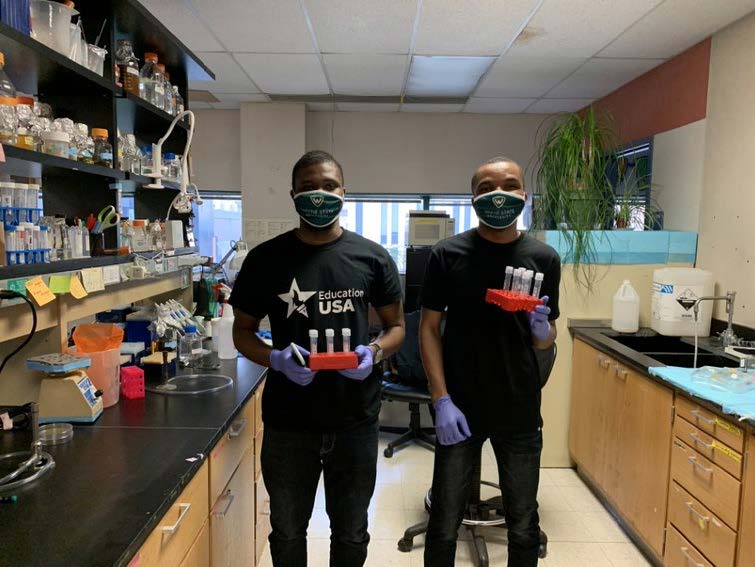 Ph.D. students Eseiwi Obaseki and Daniel Adebayo with yeast cultures