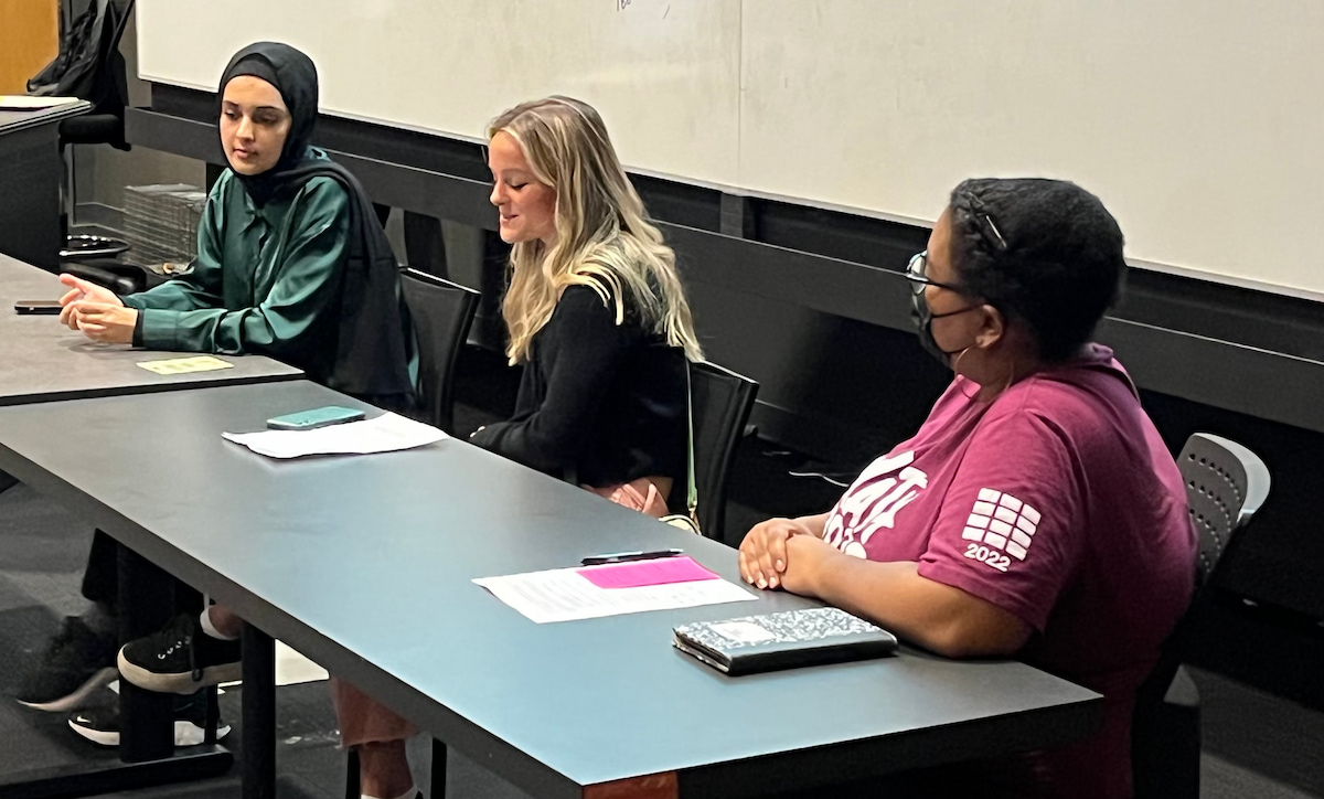 Student panelist Molly Schelosky shares her experience with mathematics panelists Marisa Henderson and Latefah Musaid listen