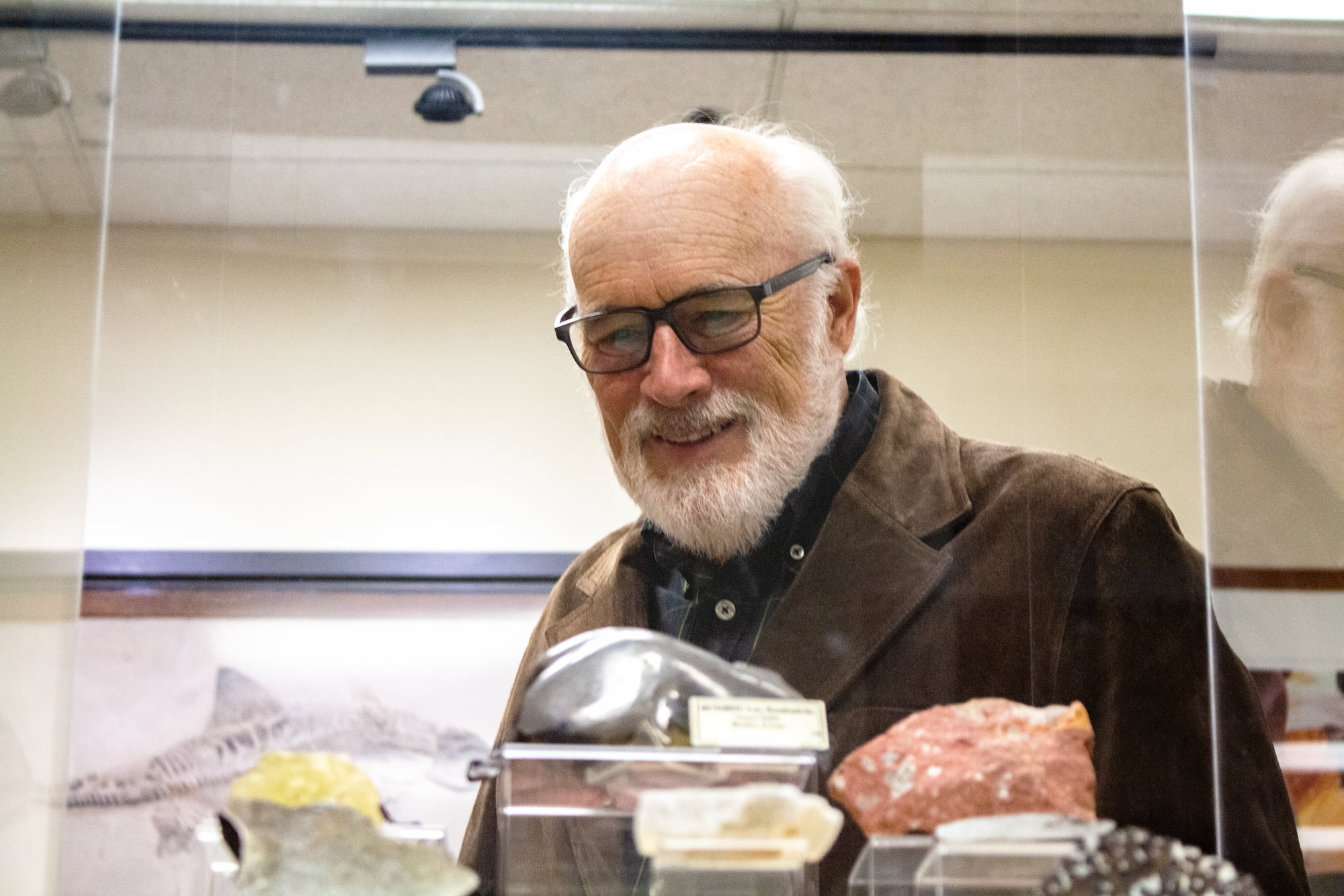 David Lowrie browsed cases in the WSU Geology Mineral Museum