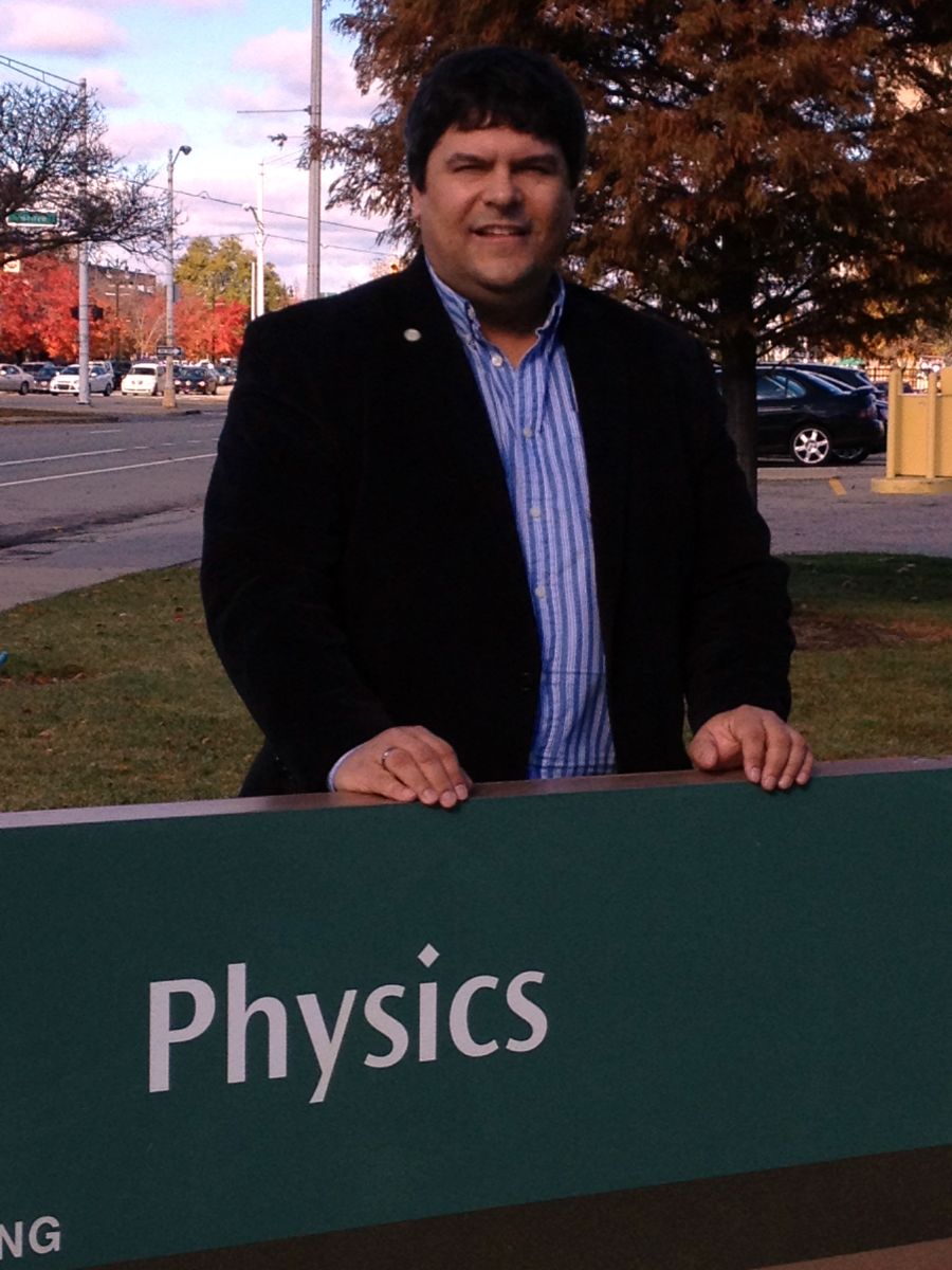 Alexey A. Petrov in front of the physics sign/building.