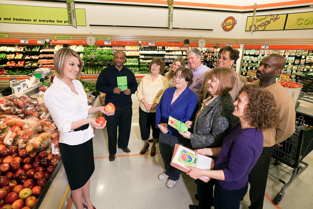 A dietician sharing with shoppers inside a grocery store.