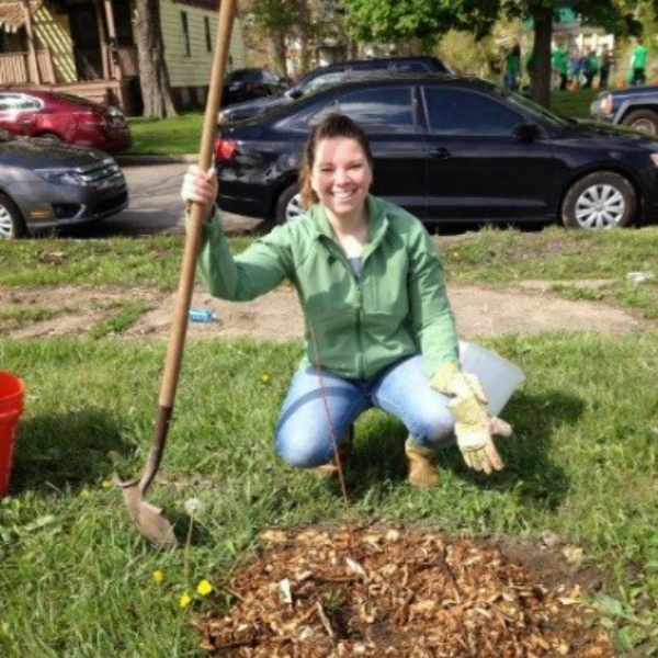 Student Pennie Pelligrini holding shovel